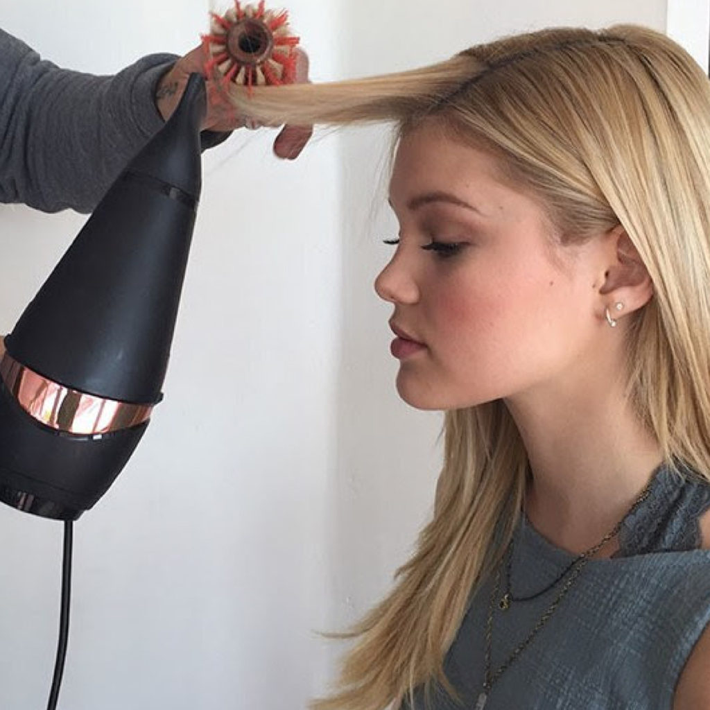 Woman having her hair blown out by a hair stylist