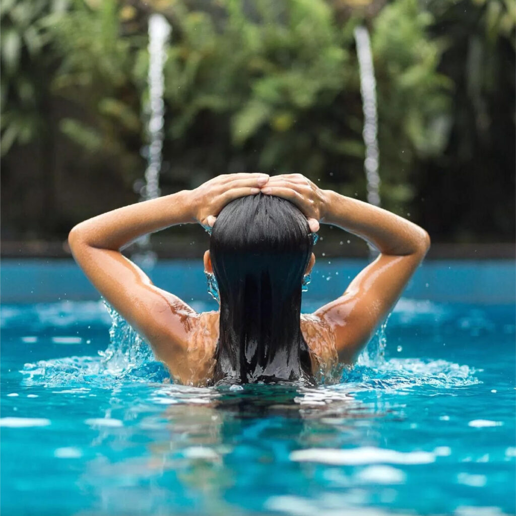 Woman in pool with long black hair