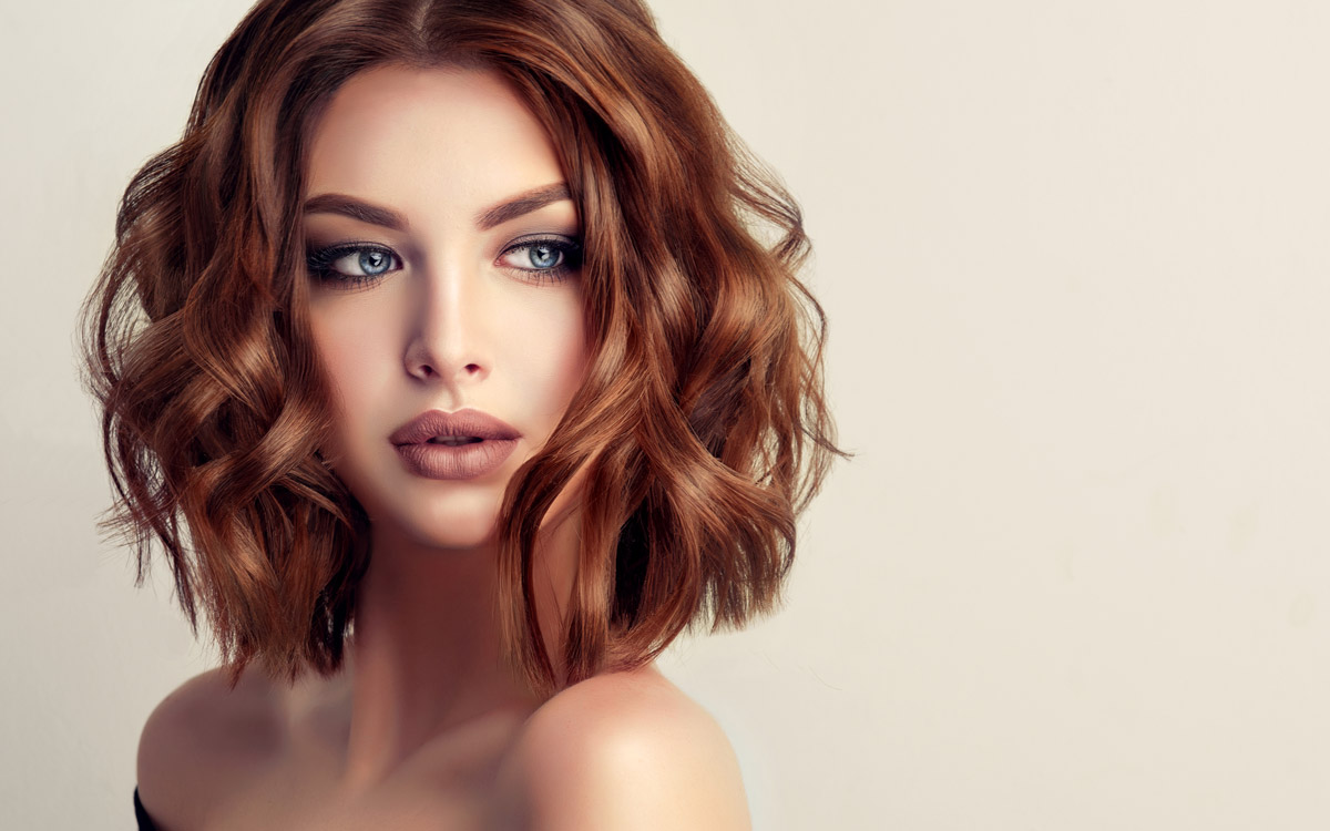 Woman with short reddish curly hair