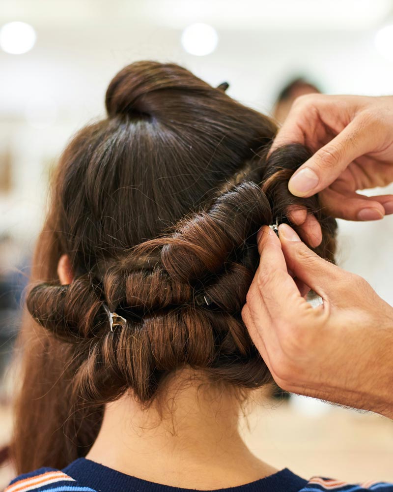 Hair stylist working on bridal updo