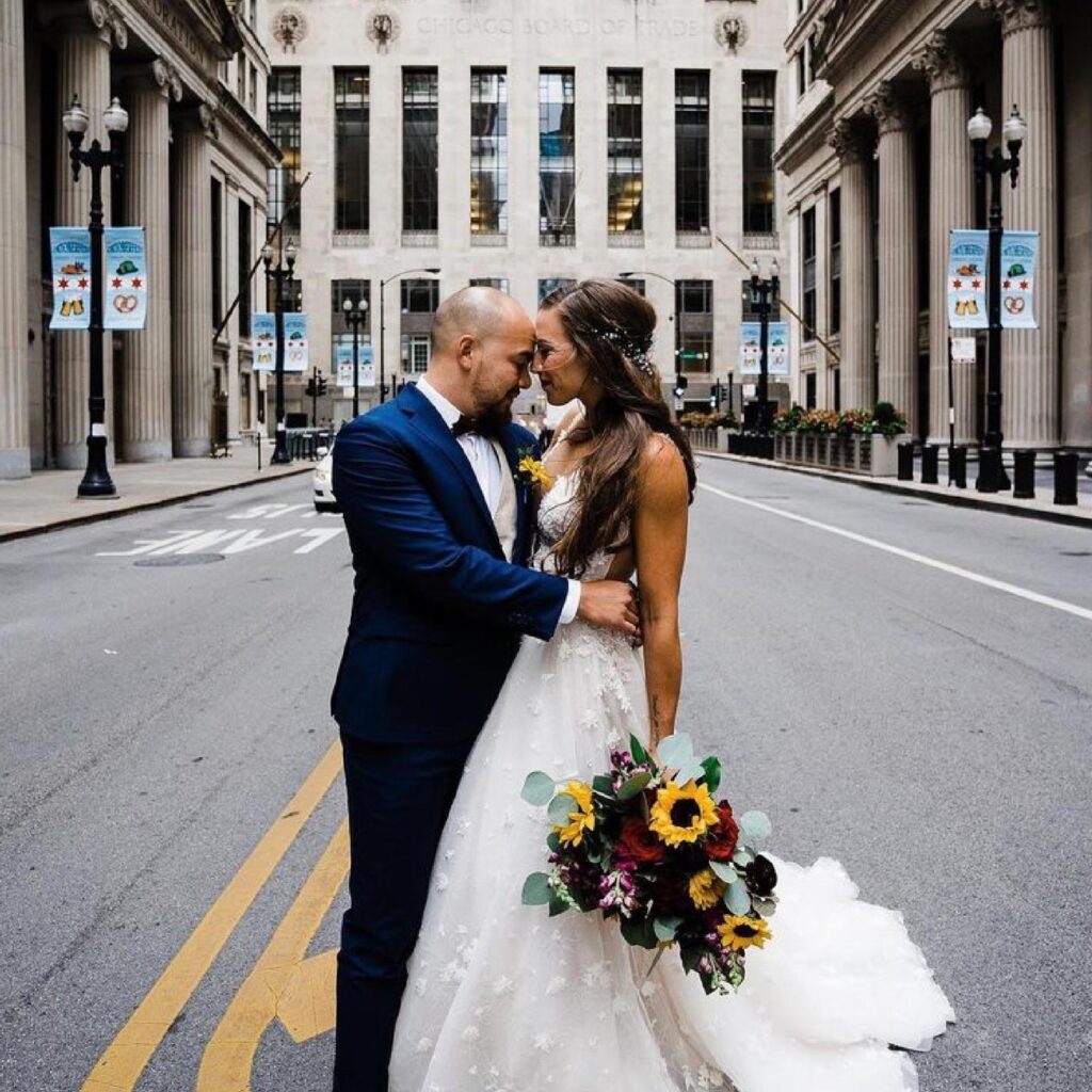 Bride posing with her groom with a simple half-up hairstyle and silver hair accessory.