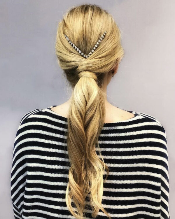 Elegant ponytail style with a silver diamond hair accessory.